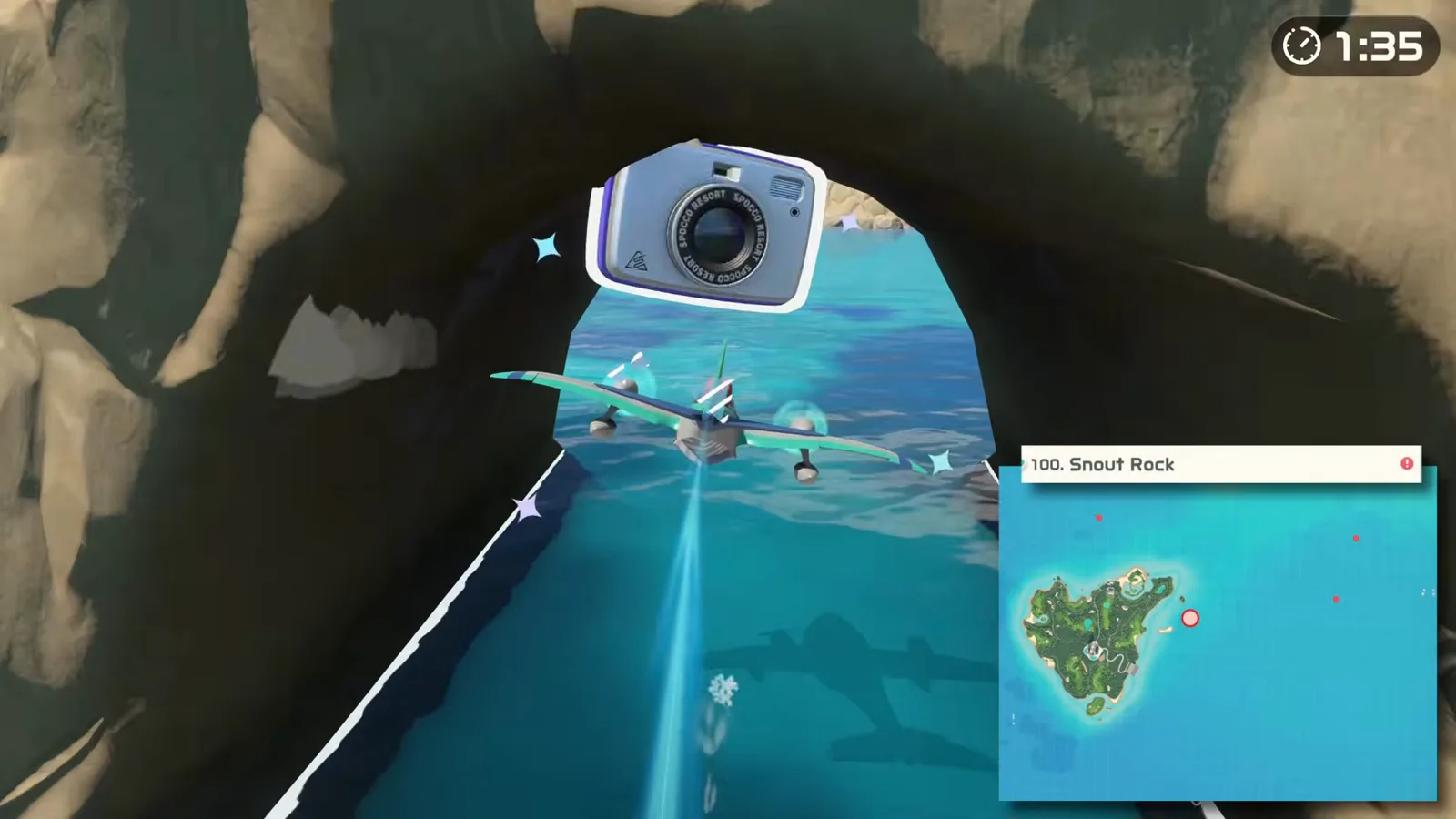 Prop plane touching the Snout Rock camera marker, photo spot 100, inside a sea cave beside Wedge Island’s golf course shoreline